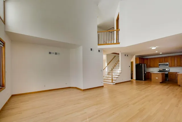 a view of an empty room and wooden floor