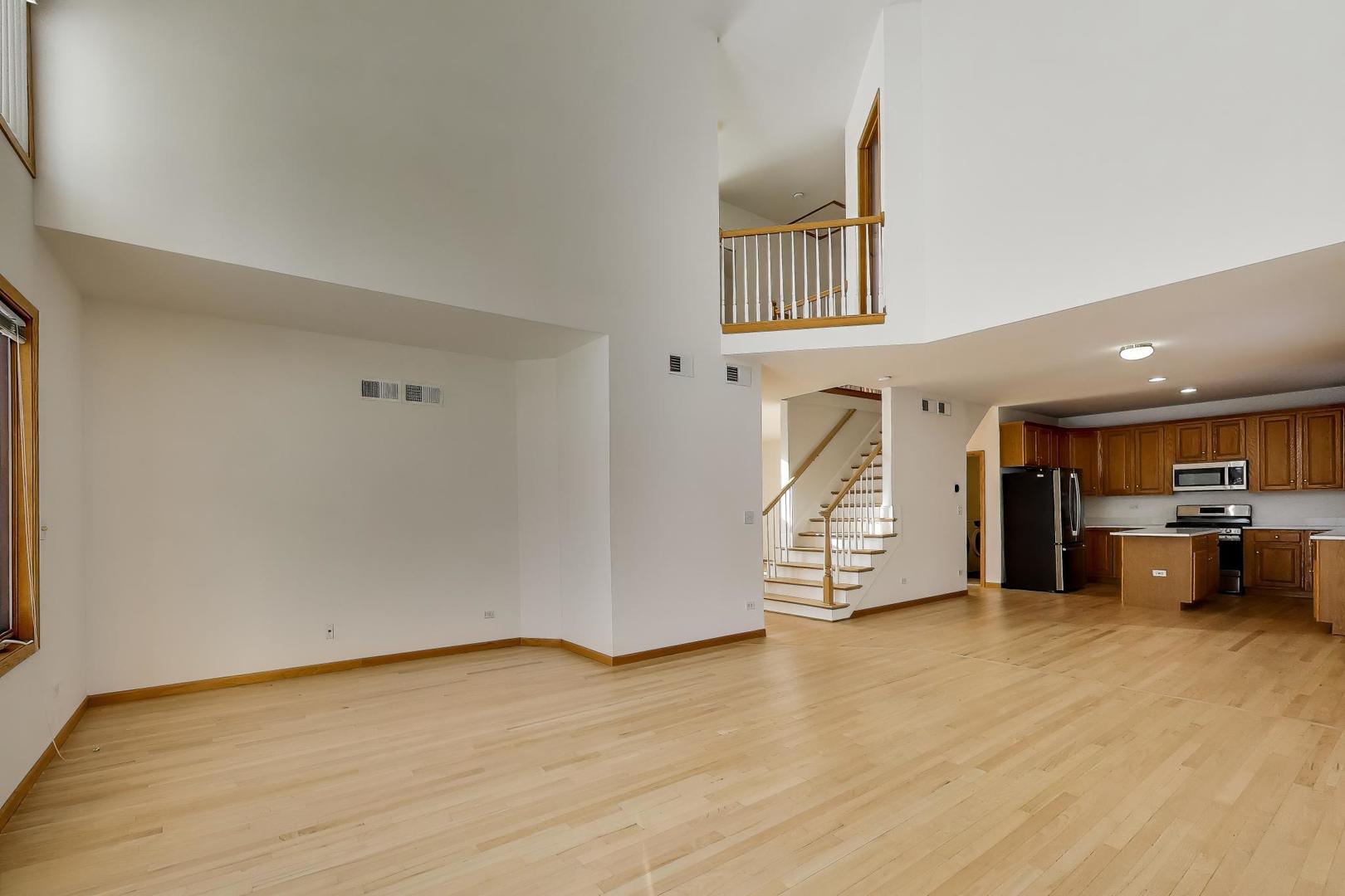 16W234 91st Street Burr Ridge, IL 60527 - Photo 16 of 50 a view of an empty room and wooden floor