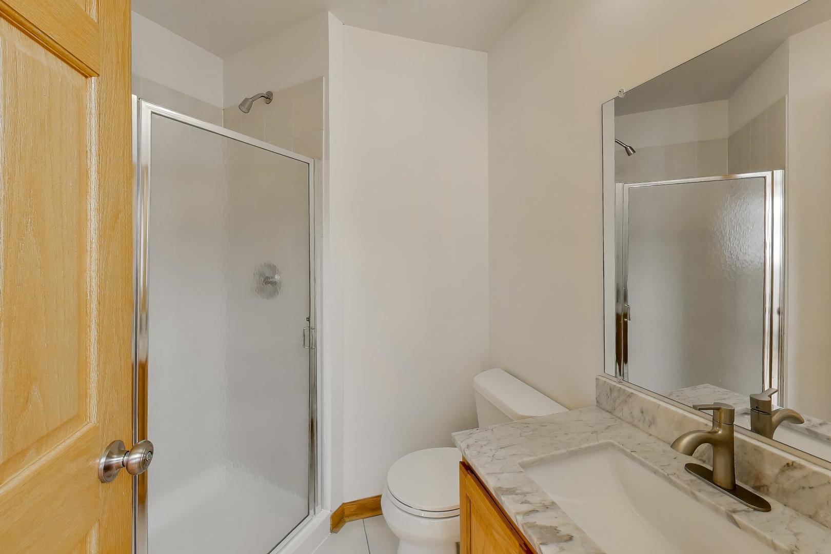 16W234 91st Street Burr Ridge, IL 60527 - Photo 18 of 50 a bathroom with a granite countertop sink toilet and shower
