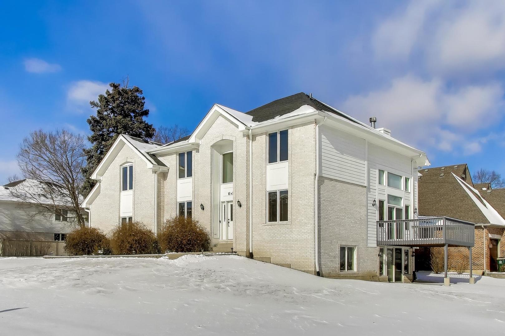 16W234 91st Street Burr Ridge, IL 60527 - Photo 2 of 50 a front view of a house with a wrought fence