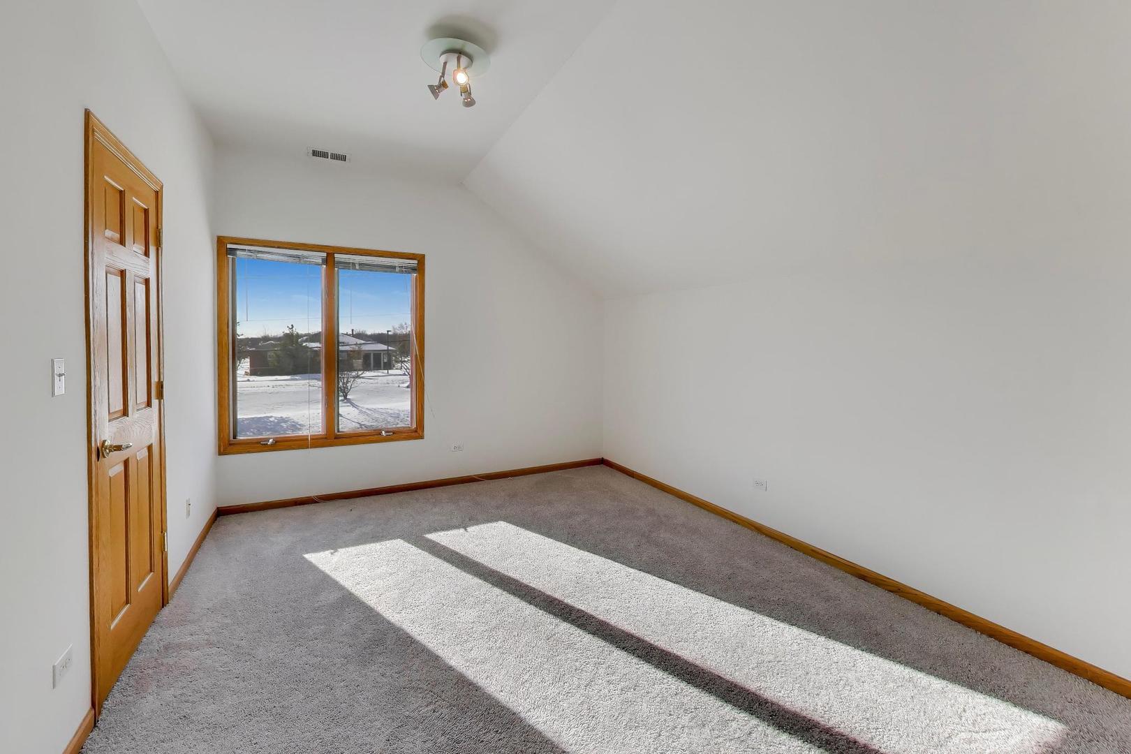 16W234 91st Street Burr Ridge, IL 60527 - Photo 25 of 50 a view of an empty room with window