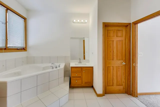 a bathroom with a sink a mirror and a bathtub