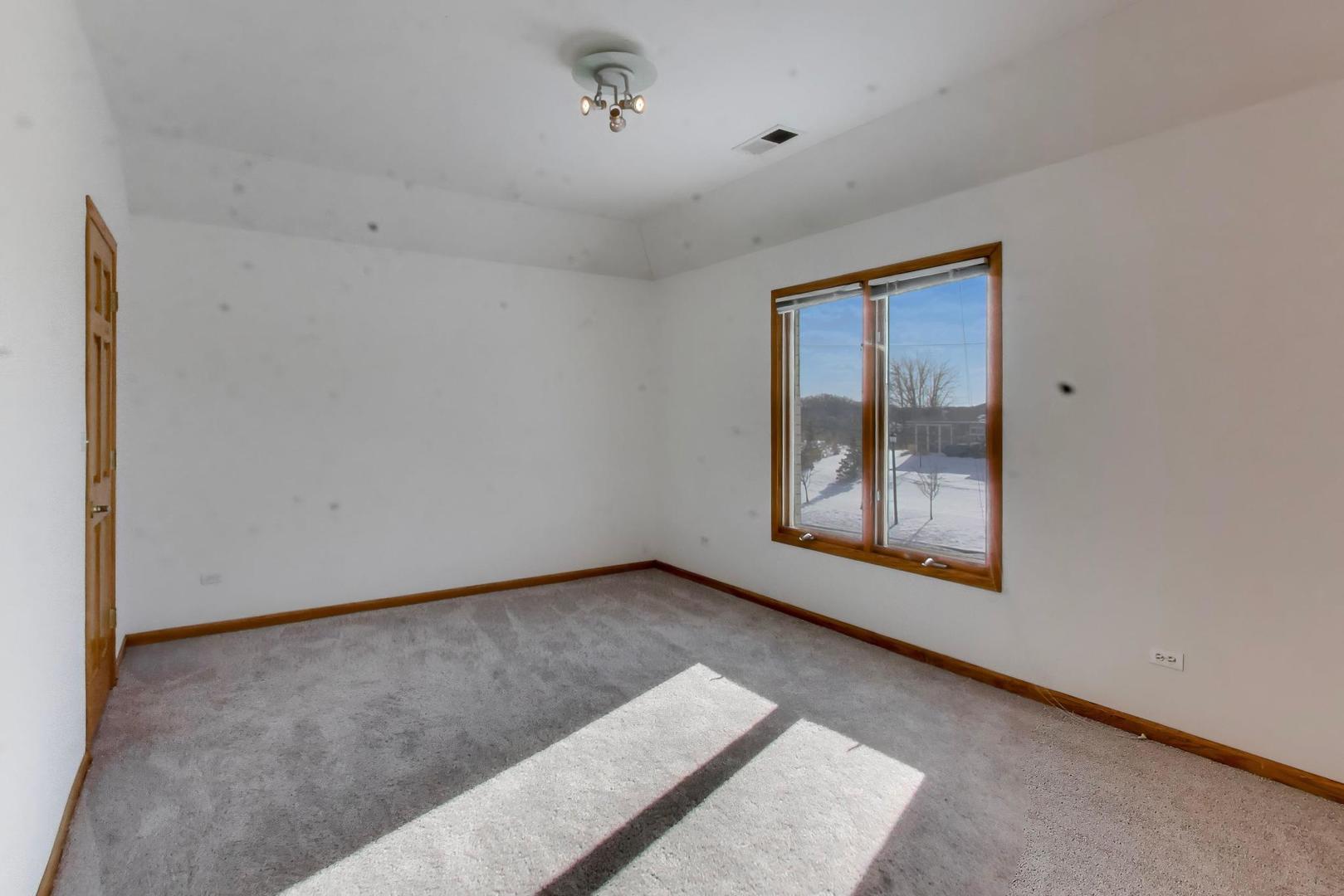 16W234 91st Street Burr Ridge, IL 60527 - Photo 30 of 50 a view of an empty room with a window