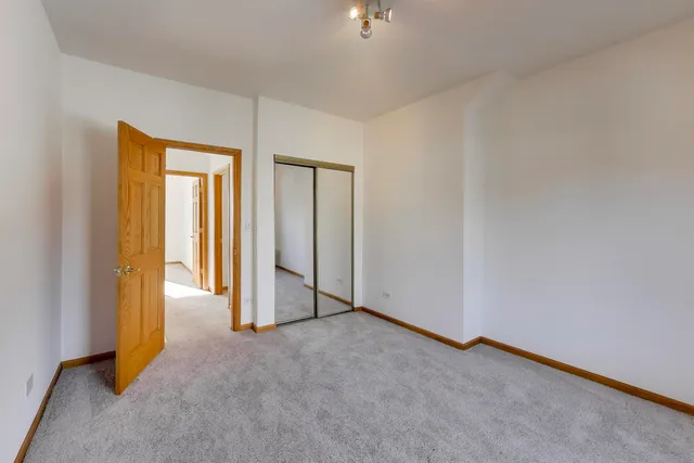 a view of an empty room and a bathroom