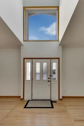 a view of an entryway with wooden floor