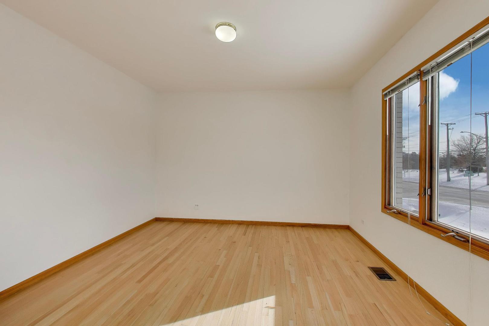 16W234 91st Street Burr Ridge, IL 60527 - Photo 6 of 50 a view of empty room with wooden floor and fan