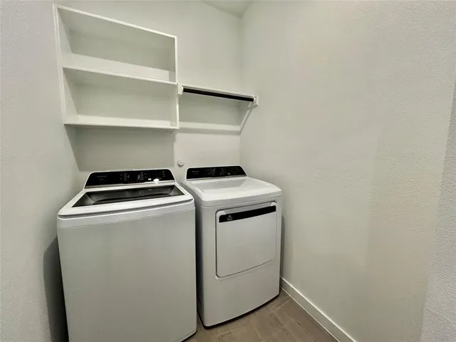 a view of backyard with barbeque oven and wooden fence