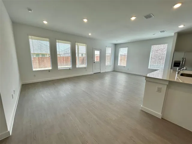 a kitchen with a sink and white cabinets