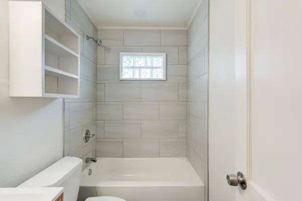 a bath tub sitting next to a white toilet