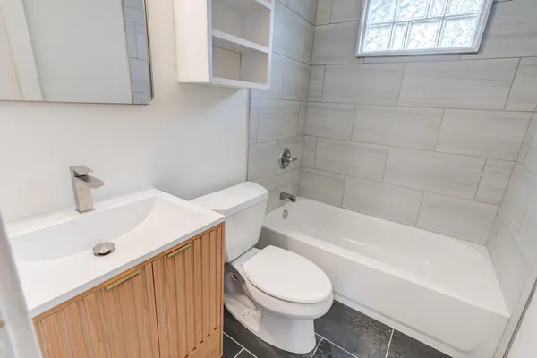 a white toilet sitting next to a bathroom sink
