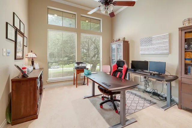 a living room with furniture a flat screen tv and a large window