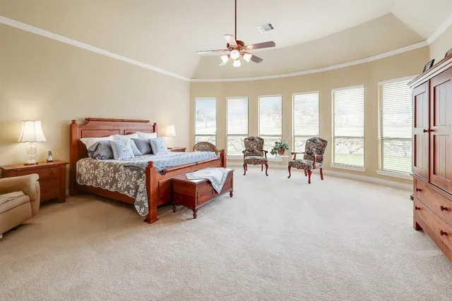 a living room with furniture and large windows