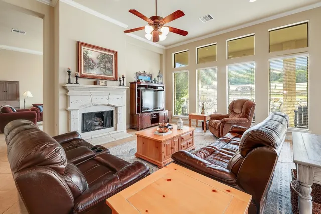 a living room with furniture fireplace and a large window
