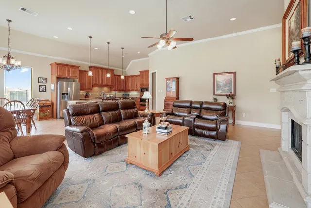 a living room with fireplace furniture and a chandelier