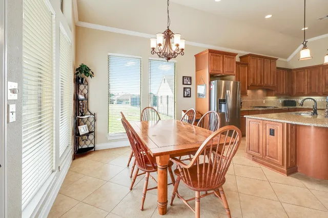a dining room with furniture and chandelier
