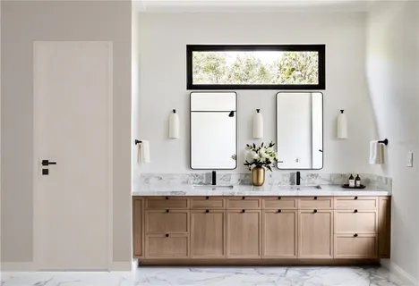 a bathroom with sinks granite vanity and a mirror