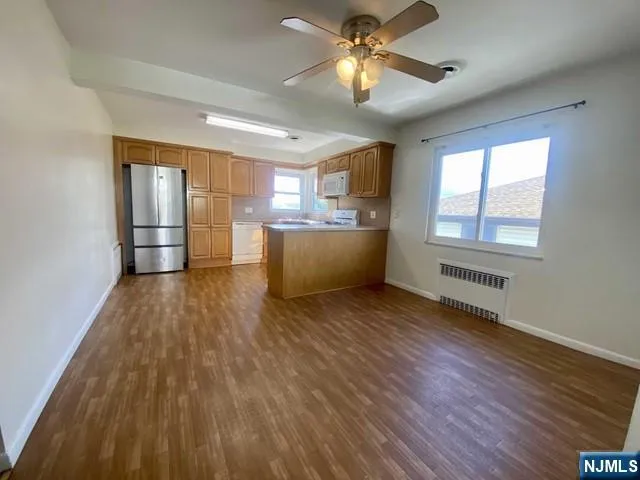 a view of a room with chandelier and wooden floors