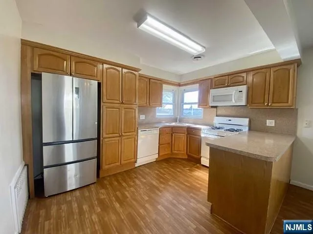 a kitchen with stainless steel appliances a refrigerator and a stove top oven