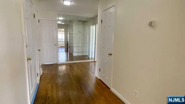 a view of a hallway with wooden floor