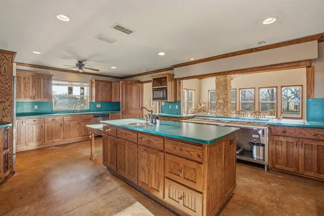 a kitchen with stainless steel appliances granite countertop a stove and a sink