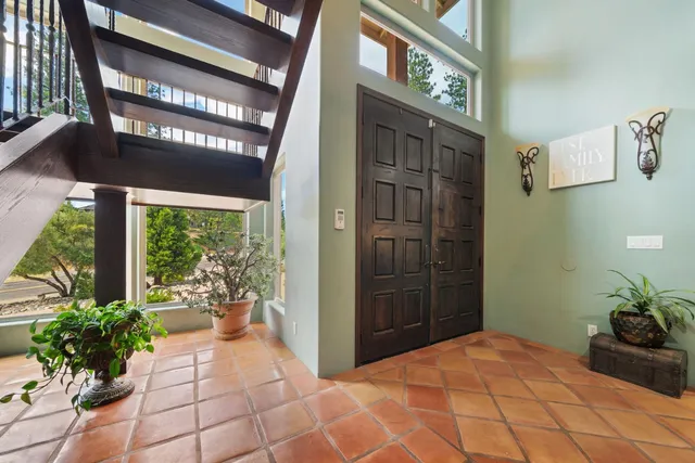 a kitchen with stainless steel appliances kitchen island granite countertop a refrigerator and a stove top oven