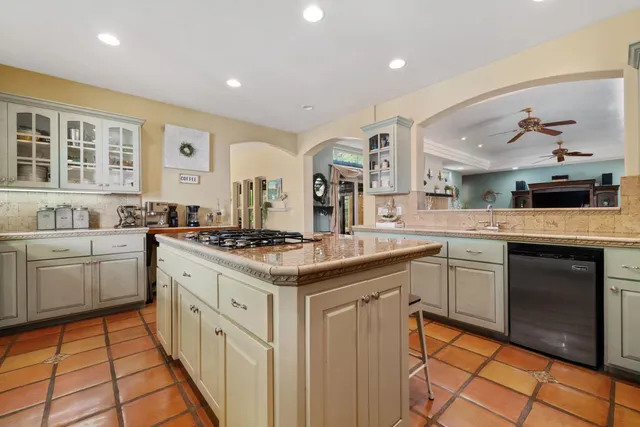 a bathroom with a granite countertop double vanity sink and a large mirror