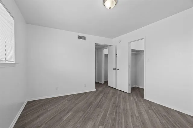a bathroom with a granite countertop sink toilet a mirror and shower