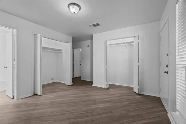a view of a room with wooden floor