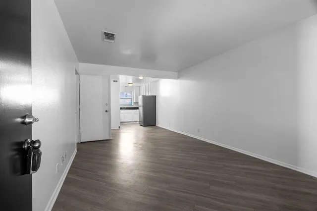 a view of a kitchen with a refrigerator and a sink