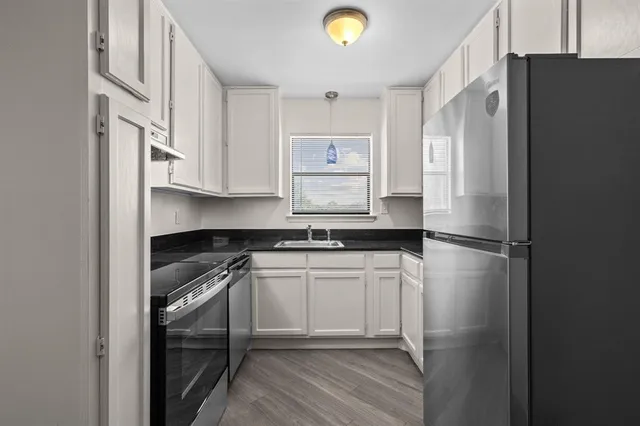 a kitchen with white cabinets and a sink