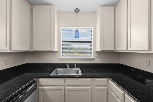 a view of a kitchen with a refrigerator and a stove top oven