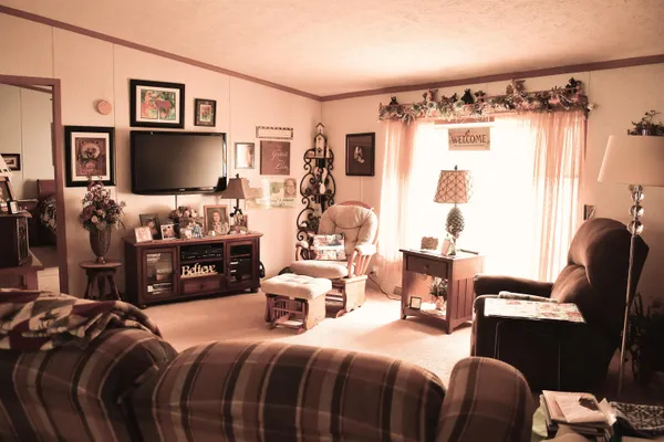 a bedroom with a bed furniture and a large window