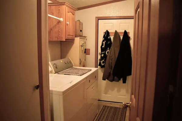 a view of walk in closet with clothes