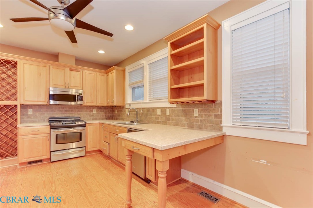 144 Meredith Street Hampton, VA 23669 - Photo 18 of 36 a kitchen with a stove a sink and a refrigerator