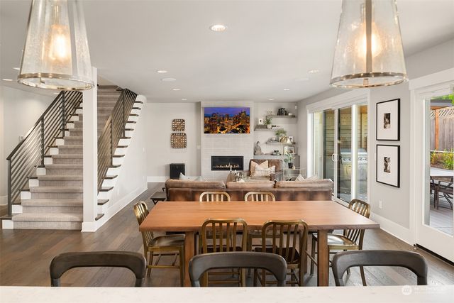 a dining room with furniture a rug and wooden floor