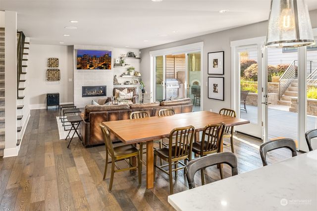 a living room with furniture a fireplace and a large window