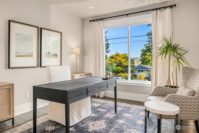 a bedroom with a bed a large window with the outer view