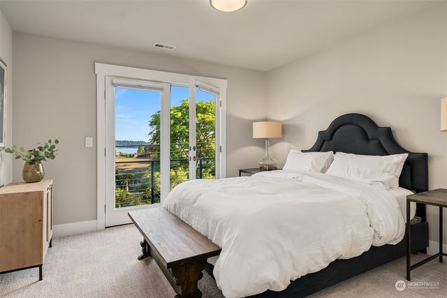 a bedroom with a large bed and a window