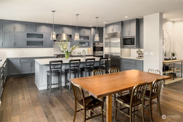a view of a dining room with furniture wooden floor and chandelier