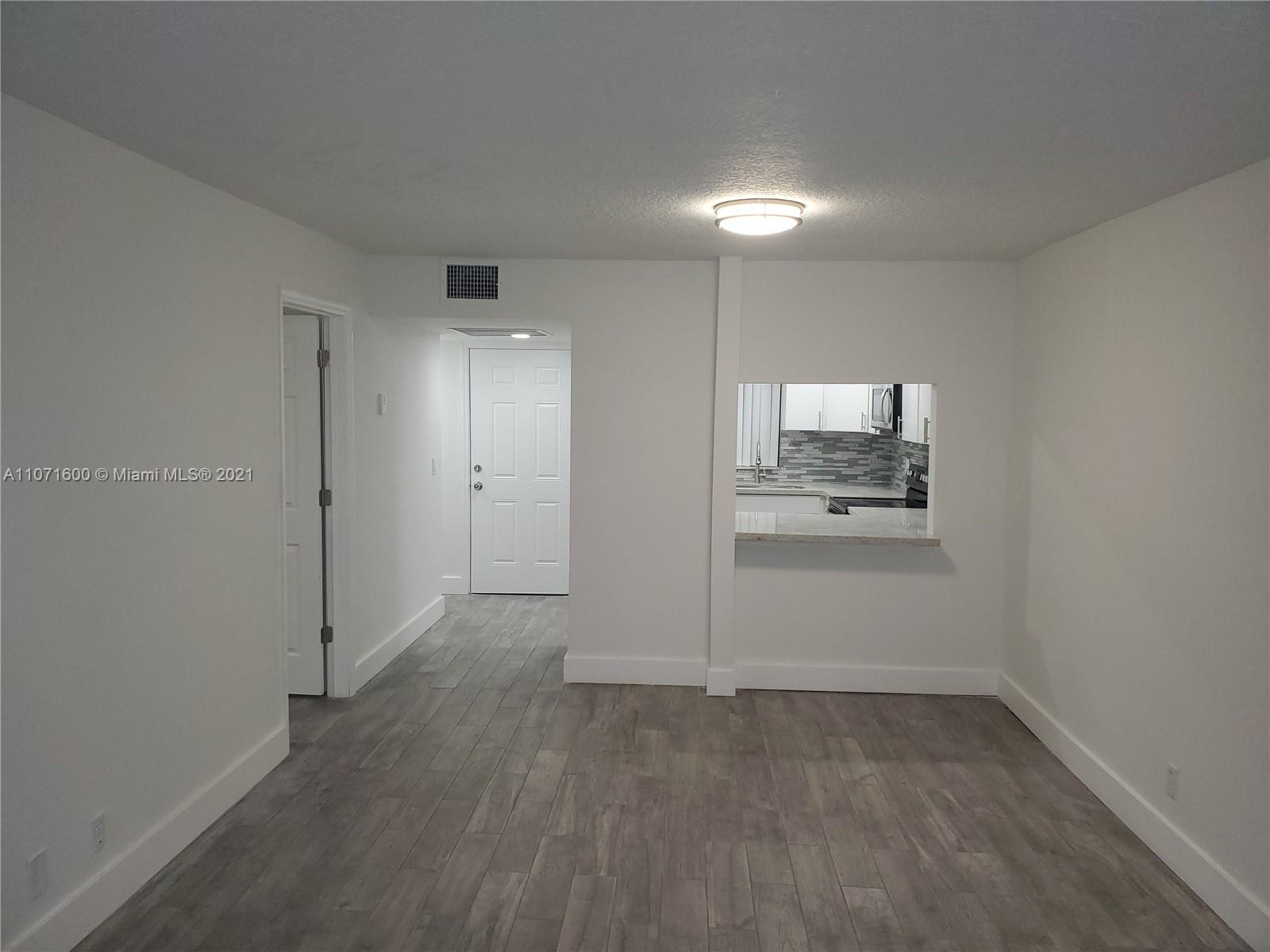 9431 Live Oak Place, Unit 108 Davie, FL 33324 - Photo 16 of 27 a view of a kitchen with refrigerator and microwave