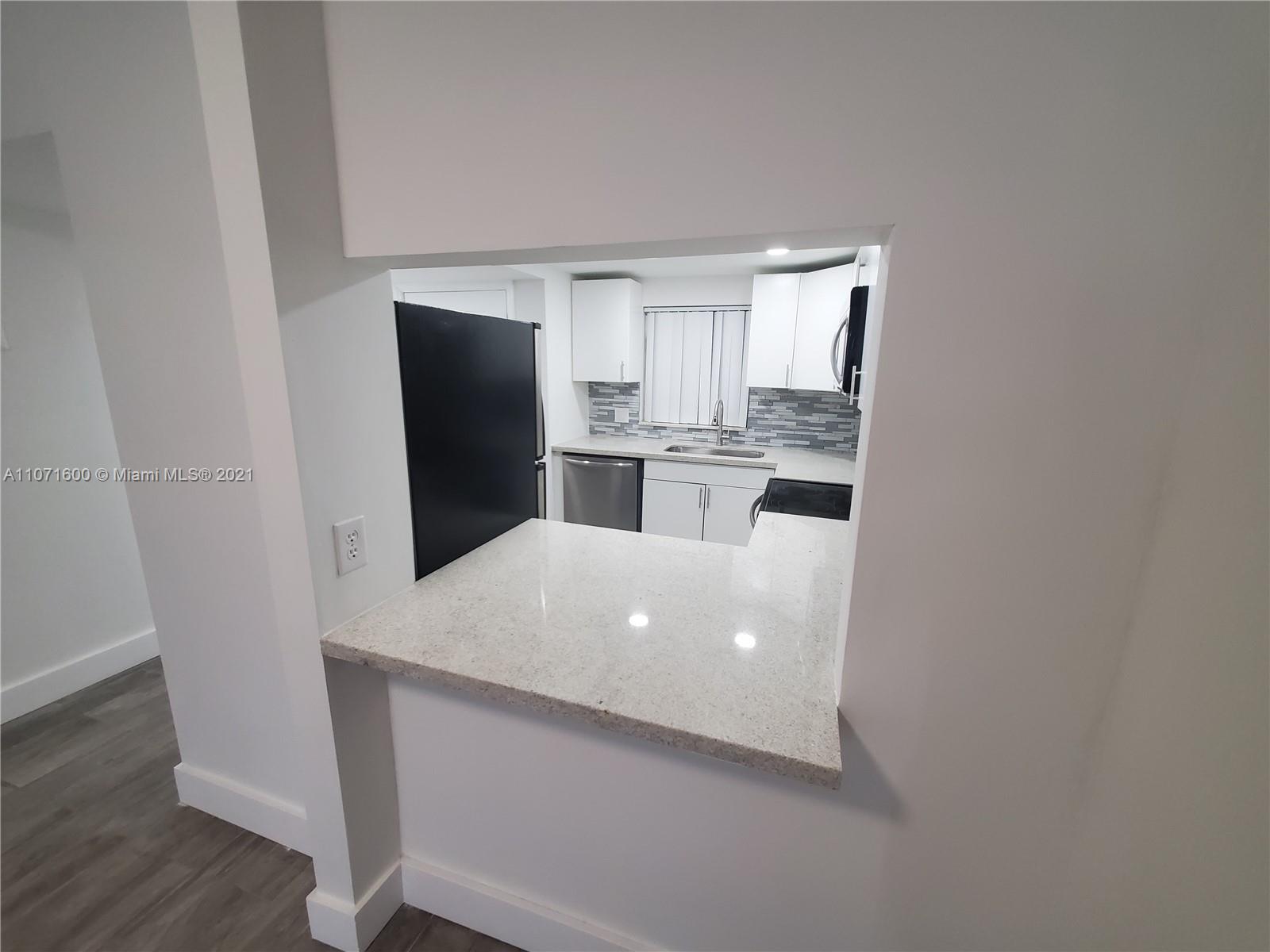 9431 Live Oak Place, Unit 108 Davie, FL 33324 - Photo 18 of 27 a kitchen with stainless steel appliances a refrigerator and a stove
