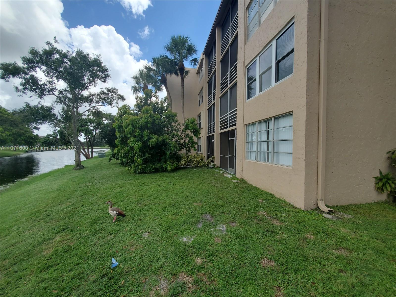 9431 Live Oak Place, Unit 108 Davie, FL 33324 - Photo 24 of 27 a view of an house with backyard space and garden