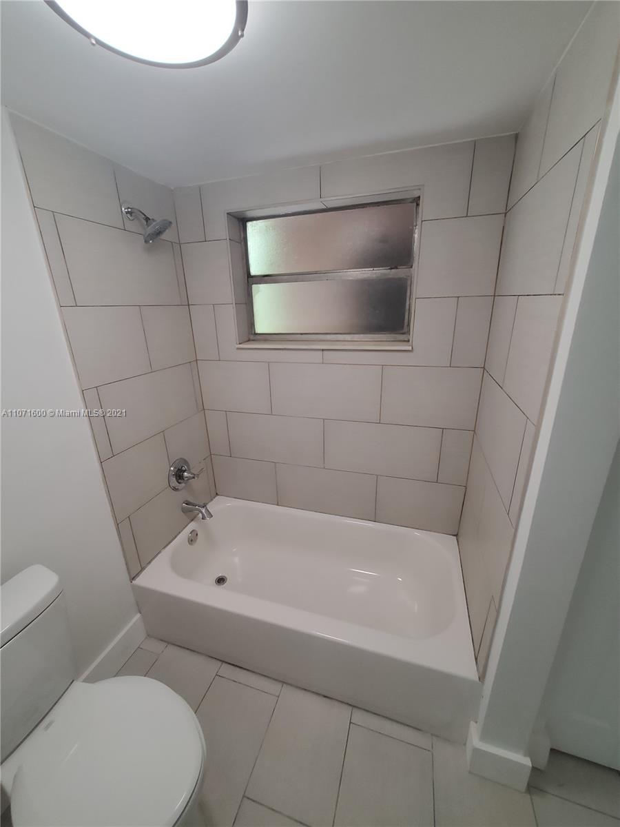 9431 Live Oak Place, Unit 108 Davie, FL 33324 - Photo 7 of 27 a white bath tub sitting next to a white toilet