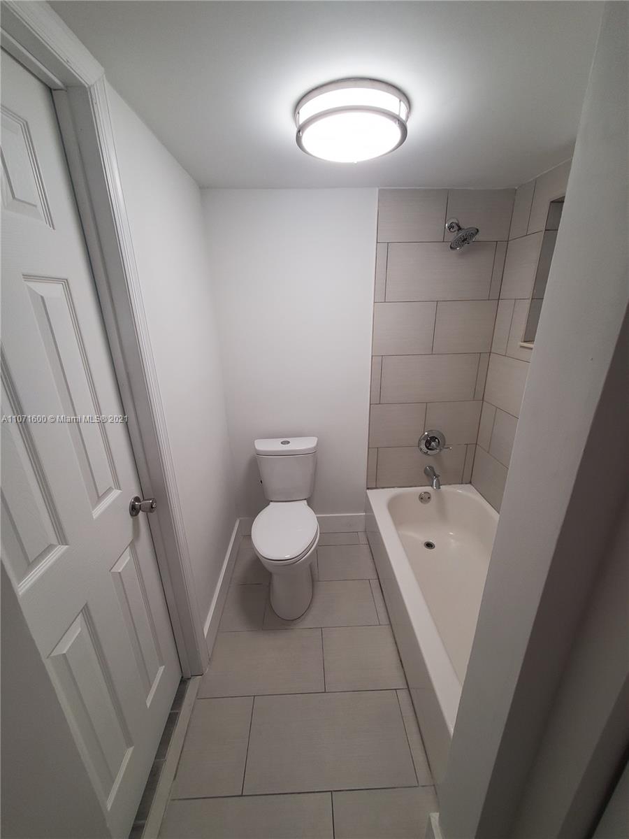 9431 Live Oak Place, Unit 108 Davie, FL 33324 - Photo 8 of 27 a bathroom with a sink a toilet and a mirror