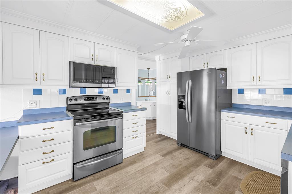 1100 South Belcher Road, Unit 502 Largo, FL 33771 - Photo 10 of 51 a kitchen with stainless steel appliances a stove microwave and refrigerator
