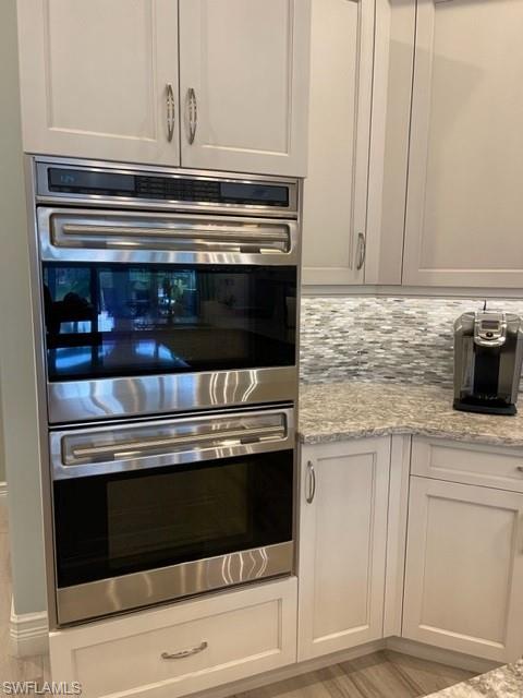 2067 Mission Drive Naples, FL 34109 - Photo 14 of 43 a stove top oven sitting inside of a kitchen