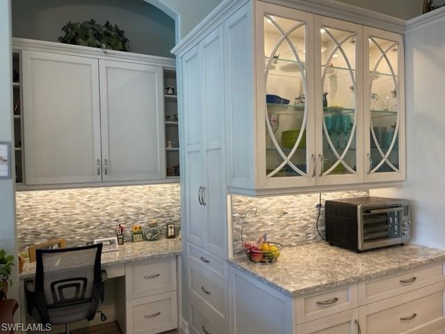2067 Mission Drive Naples, FL 34109 - Photo 15 of 43 a kitchen with stainless steel appliances granite countertop a stove a microwave and a sink