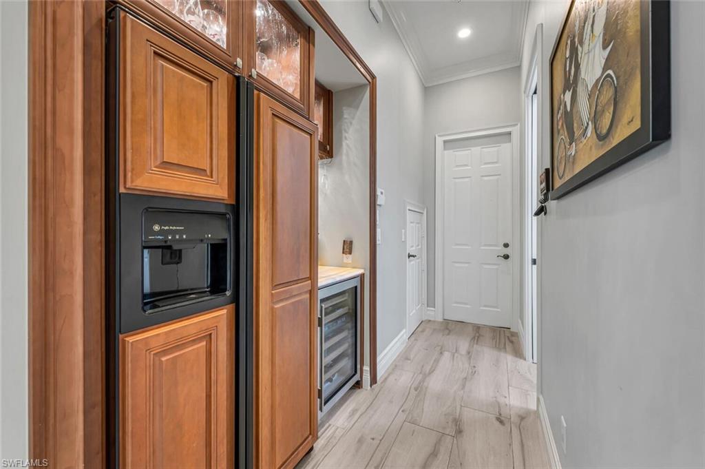 2067 Mission Drive Naples, FL 34109 - Photo 18 of 43 a view of a hallway with wooden floor and staircase