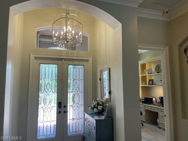 2067 Mission Drive Naples, FL 34109 - Photo 23 of 43 a view of a chandelier fan and wooden floor