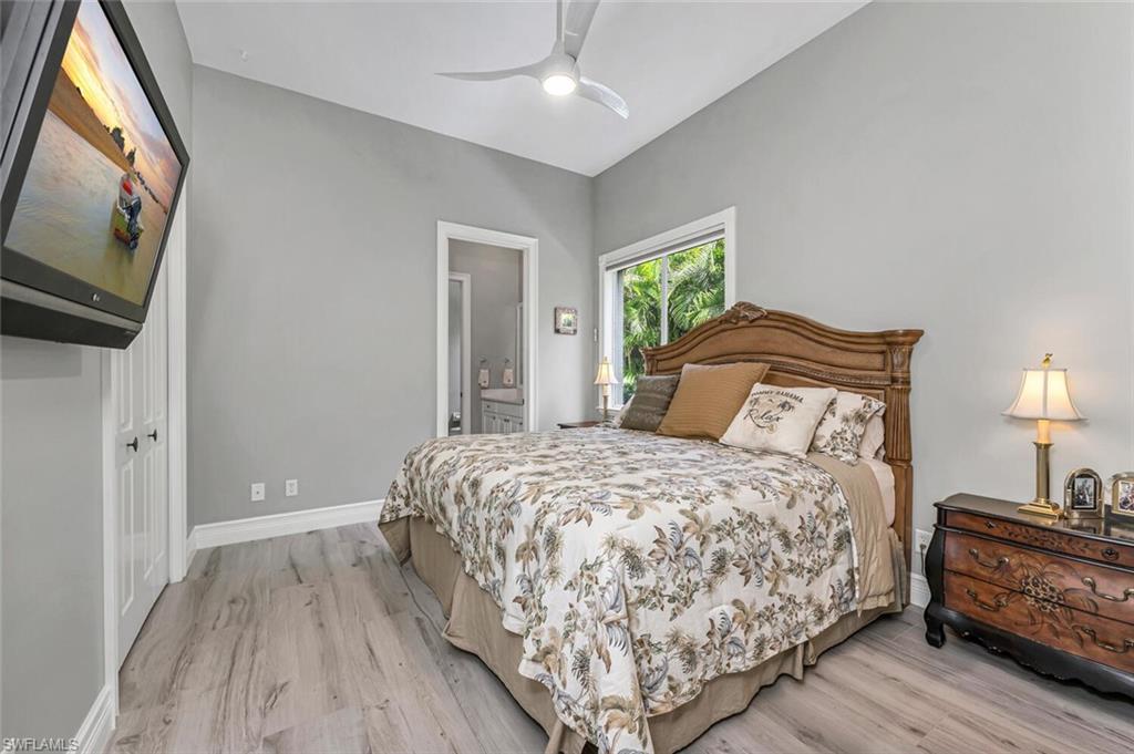 2067 Mission Drive Naples, FL 34109 - Photo 31 of 43 a bedroom with a bed and a flat tv screen on dresser